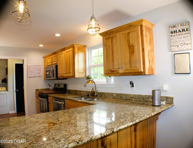 3009 S Monroe Ave, Joplin, MO 64804 - kitchen featuring stainless steel appliances, light stone countertops, washer / dryer, recessed lighting, and hanging light fixtures