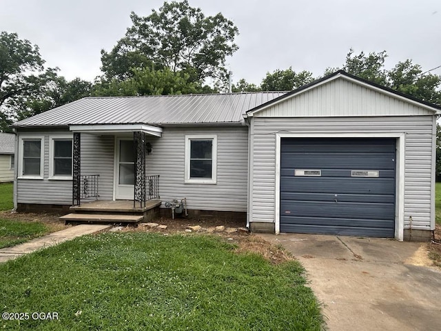 419 Depot St, Oswego, KS 67356 - ranch-style home featuring concrete driveway, an attached garage, a front lawn, a metal roof, and crawl space