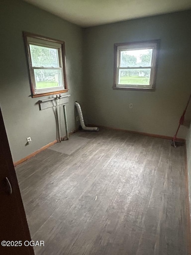 419 Depot St, Oswego, KS 67356 - unfurnished room featuring plenty of natural light and wood finished floors