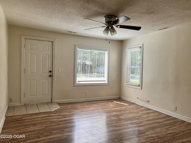 821 New Hampshire Ave, Joplin, MO 64801 - entrance foyer with wood finished floors, a ceiling fan, and a textured ceiling
