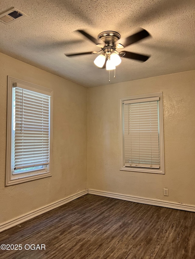 821 New Hampshire Ave, Joplin, MO 64801 - unfurnished room featuring dark wood-style floors, a textured ceiling, and ceiling fan