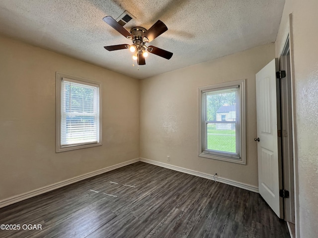 821 New Hampshire Ave, Joplin, MO 64801 - unfurnished room with dark wood-style flooring, a textured ceiling, and ceiling fan