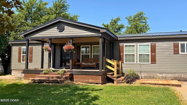 4950 SE 118th St, Galena, KS 66739 - view of front of home featuring a front lawn, a porch, and a metal roof