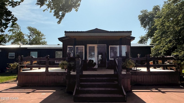 4950 SE 118th St, Galena, KS 66739 - view of front facade featuring a wooden deck and a metal roof