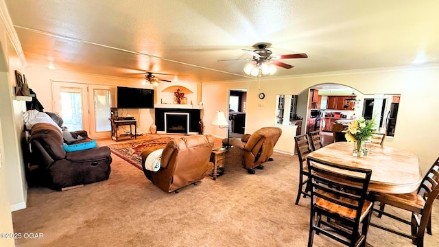 4950 SE 118th St, Galena, KS 66739 - living room featuring a ceiling fan, ornamental molding, light carpet, and arched walkways