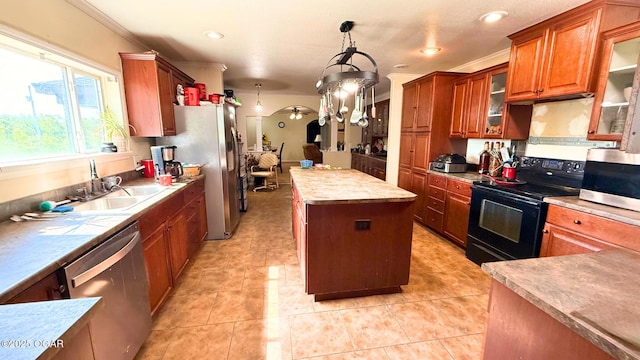 4950 SE 118th St, Galena, KS 66739 - kitchen featuring stainless steel appliances, a kitchen island, brown cabinets, light countertops, and hanging light fixtures
