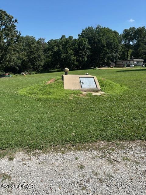 8305A Ivory Rd, Reeds, MO 64859 - view of storm shelter featuring a lawn