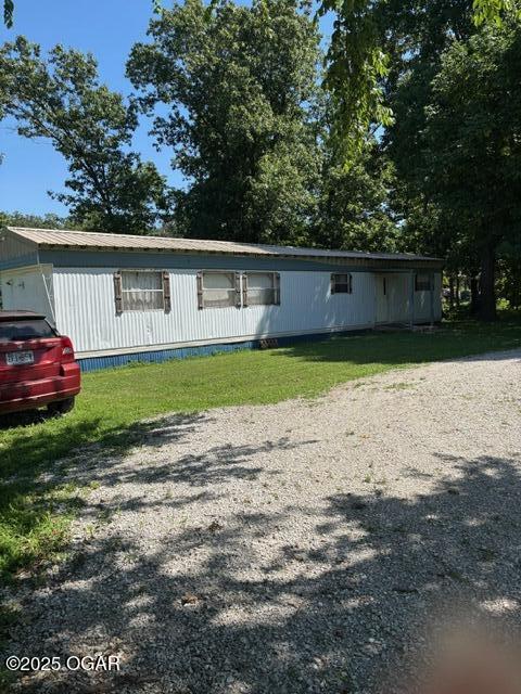 8305A Ivory Rd, Reeds, MO 64859 - manufactured / mobile home with a front lawn