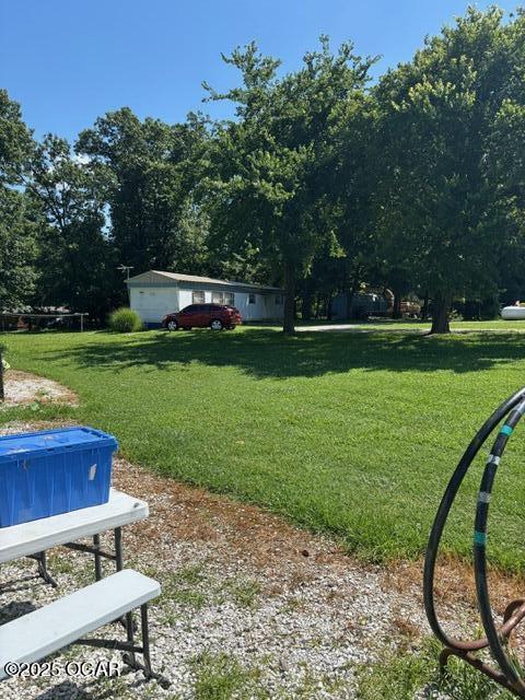 8305A Ivory Rd, Reeds, MO 64859 - view of grassy yard featuring view of scattered trees