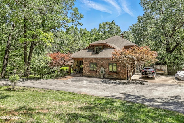 5623 Rivercrest Valley Dr, Joplin, MO 64804 - view of front facade with brick siding, a shingled roof, and a chimney