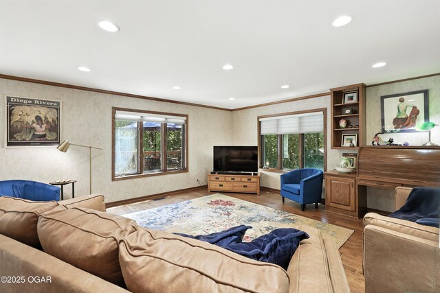 5623 Rivercrest Valley Dr, Joplin, MO 64804 - living room featuring plenty of natural light, ornamental molding, recessed lighting, and wood finished floors