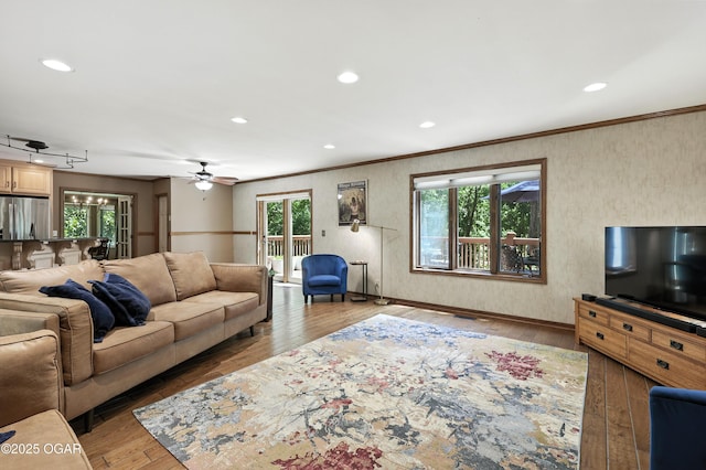 5623 Rivercrest Valley Dr, Joplin, MO 64804 - living room with healthy amount of natural light, wood-type flooring, crown molding, a ceiling fan, and recessed lighting