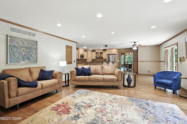 5623 Rivercrest Valley Dr, Joplin, MO 64804 - living area with ornamental molding, light wood-style floors, ceiling fan, and recessed lighting