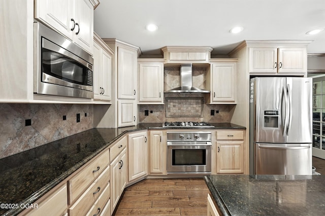 5623 Rivercrest Valley Dr, Joplin, MO 64804 - kitchen with stainless steel appliances, wall chimney exhaust hood, dark wood-style flooring, dark stone counters, and backsplash