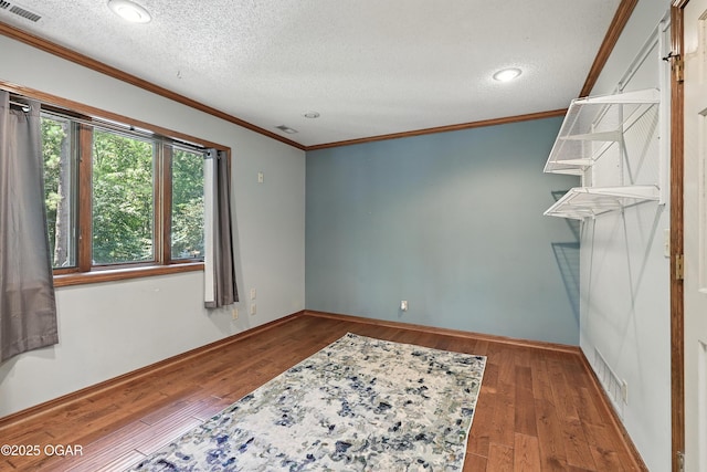 5623 Rivercrest Valley Dr, Joplin, MO 64804 - empty room featuring crown molding, hardwood / wood-style floors, a textured ceiling, and recessed lighting