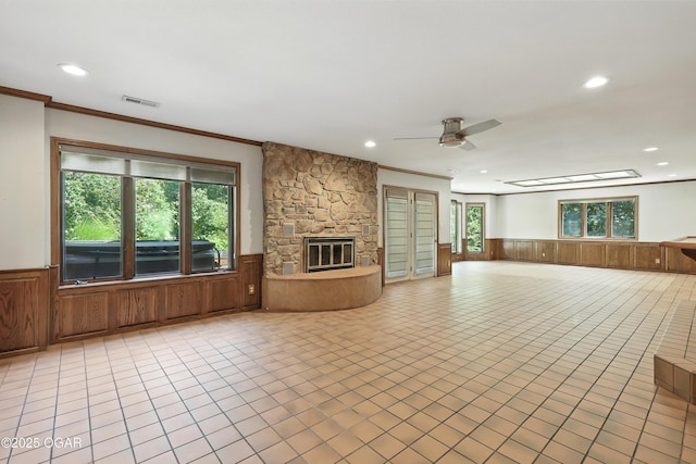 5623 Rivercrest Valley Dr, Joplin, MO 64804 - unfurnished living room featuring wainscoting, recessed lighting, a ceiling fan, crown molding, and a fireplace