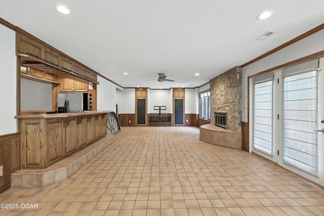 5623 Rivercrest Valley Dr, Joplin, MO 64804 - unfurnished living room featuring wainscoting, a fireplace, ornamental molding, a ceiling fan, and recessed lighting