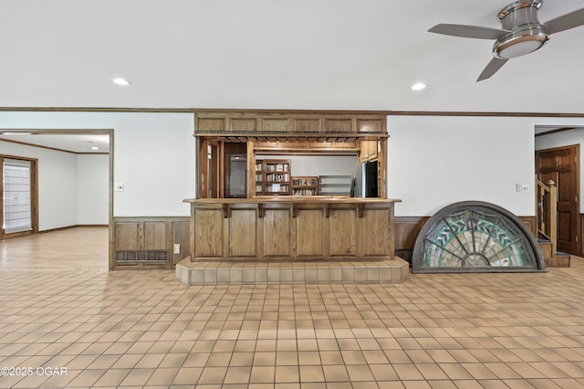 5623 Rivercrest Valley Dr, Joplin, MO 64804 - kitchen featuring freestanding refrigerator, crown molding, ceiling fan, a wainscoted wall, and recessed lighting