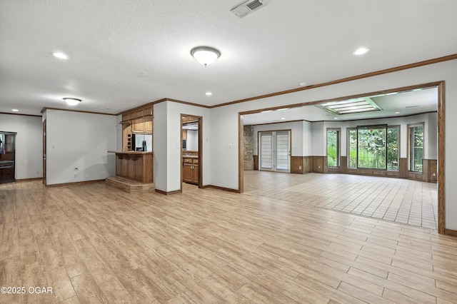 5623 Rivercrest Valley Dr, Joplin, MO 64804 - unfurnished living room with recessed lighting, ornamental molding, light wood finished floors, and a textured ceiling