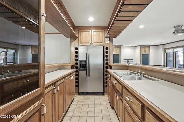 5623 Rivercrest Valley Dr, Joplin, MO 64804 - kitchen with stainless steel fridge, light countertops, light tile patterned floors, recessed lighting, and brown cabinetry