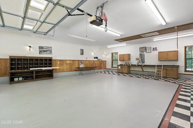 5623 Rivercrest Valley Dr, Joplin, MO 64804 - garage with a garage door opener and wood walls