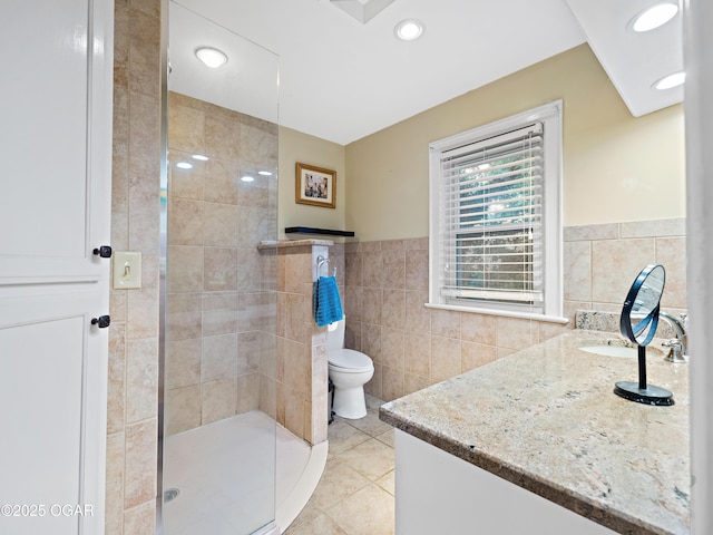 629 W Islington Pl, Joplin, MO 64801 - full bath with tile walls, vanity, a stall shower, tile patterned flooring, and a wainscoted wall