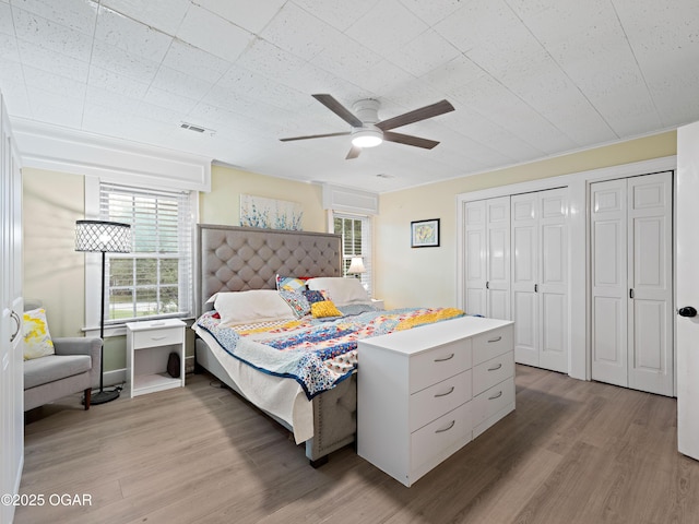 629 W Islington Pl, Joplin, MO 64801 - bedroom with wood finished floors, a ceiling fan, and multiple closets