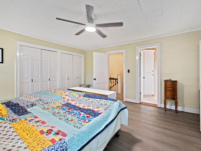 629 W Islington Pl, Joplin, MO 64801 - bedroom featuring multiple closets, wood finished floors, and ceiling fan