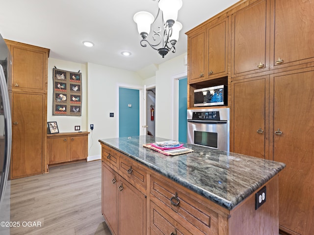 629 W Islington Pl, Joplin, MO 64801 - kitchen with appliances with stainless steel finishes, brown cabinets, light wood-style floors, recessed lighting, and a chandelier