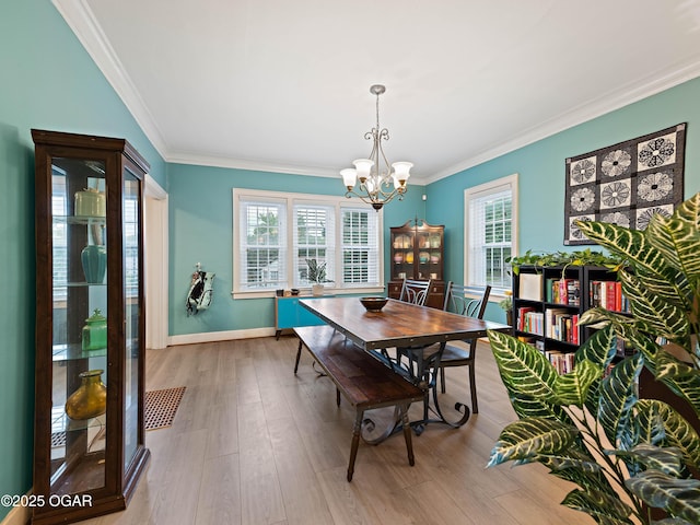 629 W Islington Pl, Joplin, MO 64801 - dining space featuring a chandelier, plenty of natural light, crown molding, and wood finished floors