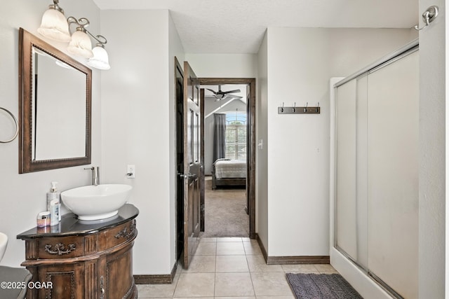 2256 N Greystone Sq, Webb City, MO 64870 - ensuite bathroom with a stall shower, a ceiling fan, vanity, and tile patterned floors