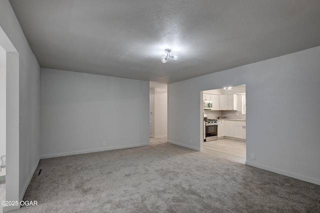233 Timber Ln, Carl Junction, MO 64834 - unfurnished living room featuring light carpet and a textured ceiling