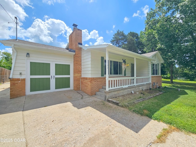 2507 N Ozark Ave, Joplin, MO 64801 - view of front of home with brick siding, covered porch, a chimney, and concrete driveway