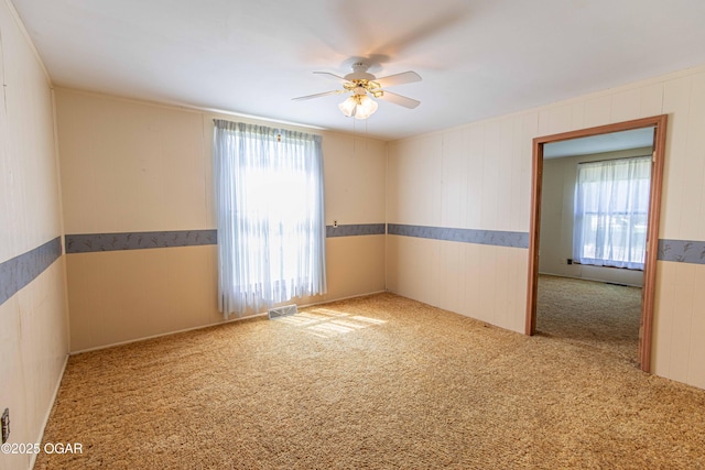 400 Broadway St, Lamar, MO 64759 - carpeted empty room with a ceiling fan