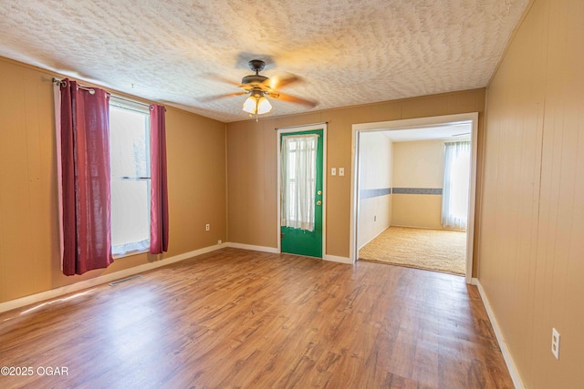 400 Broadway St, Lamar, MO 64759 - spare room featuring a ceiling fan, wood finished floors, and a textured ceiling