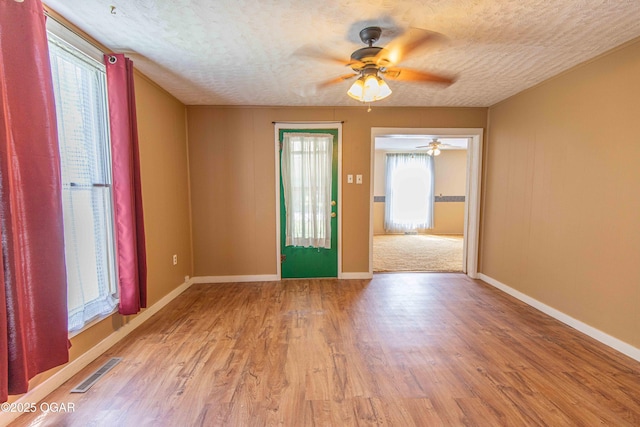 400 Broadway St, Lamar, MO 64759 - spare room featuring a ceiling fan, a textured ceiling, and light wood-style flooring