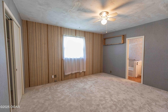 400 Broadway St, Lamar, MO 64759 - unfurnished bedroom with carpet flooring, a textured ceiling, ensuite bathroom, and a ceiling fan