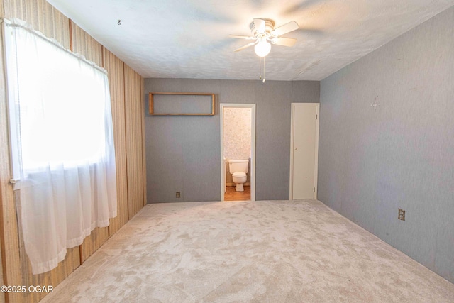 400 Broadway St, Lamar, MO 64759 - unfurnished bedroom with carpet flooring, ensuite bath, and ceiling fan