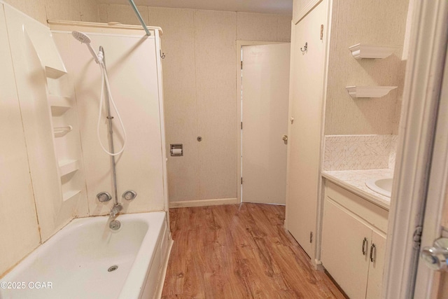 400 Broadway St, Lamar, MO 64759 - bathroom with vanity, bathing tub / shower combination, and wood finished floors