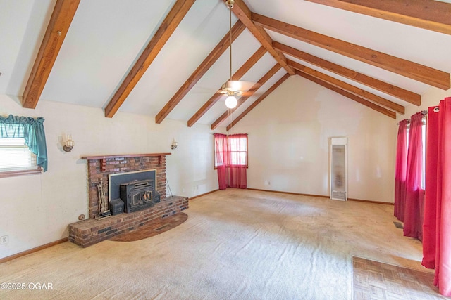 400 Broadway St, Lamar, MO 64759 - unfurnished living room featuring beamed ceiling, a wood stove, carpet flooring, a ceiling fan, and high vaulted ceiling