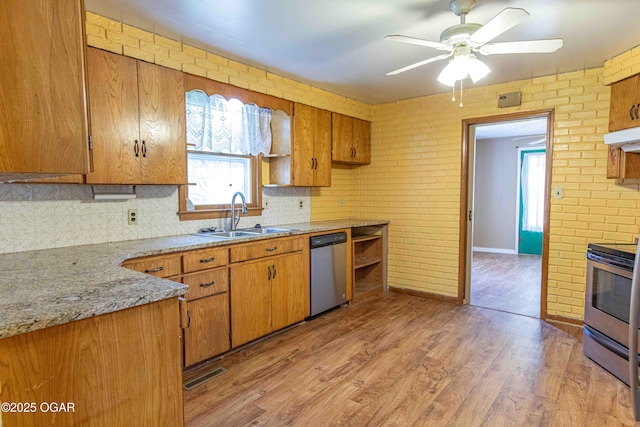 400 Broadway St, Lamar, MO 64759 - kitchen with appliances with stainless steel finishes, tasteful backsplash, plenty of natural light, light wood-style floors, and brick wall