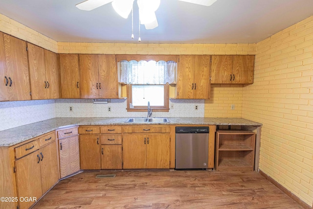 400 Broadway St, Lamar, MO 64759 - kitchen with stainless steel dishwasher, a ceiling fan, light countertops, light wood-style flooring, and brick wall
