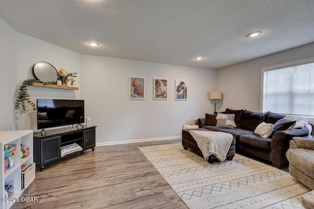 715 Wilson St, Webb City, MO 64870 - living area with light wood finished floors, a textured ceiling, and recessed lighting