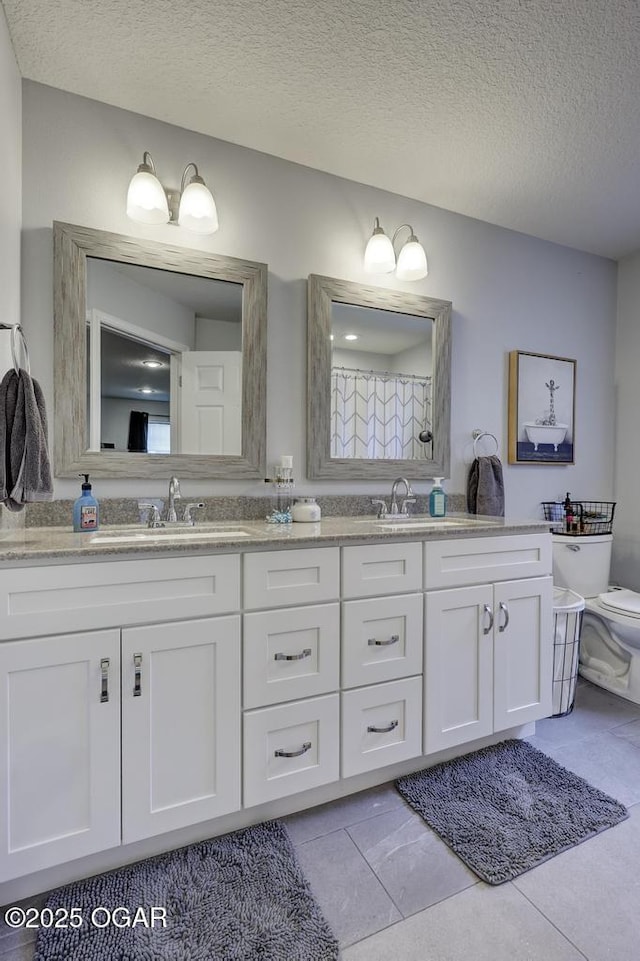 715 Wilson St, Webb City, MO 64870 - full bathroom with double vanity, a textured ceiling, and tile patterned floors