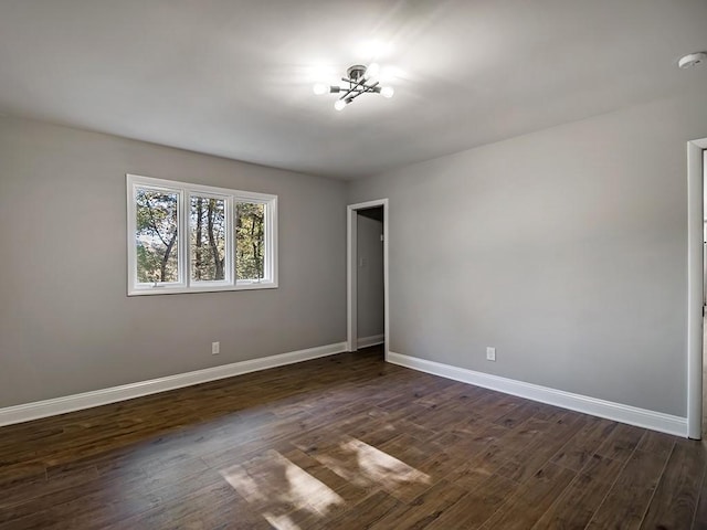 unfurnished bedroom with dark hardwood / wood-style flooring