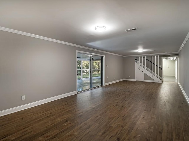 empty room with ornamental molding and dark hardwood / wood-style flooring