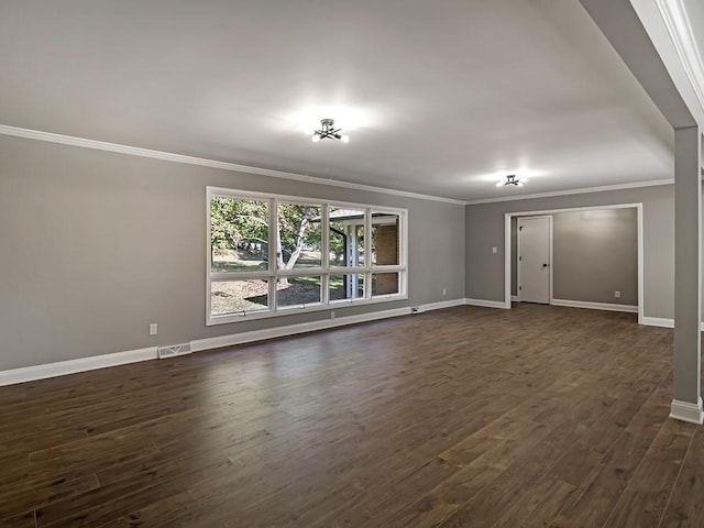 interior space with dark hardwood / wood-style flooring and crown molding