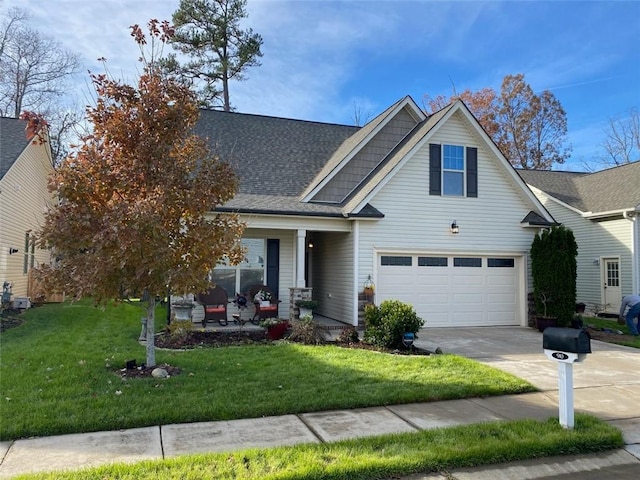 view of front facade featuring covered porch, a front yard, and a garage