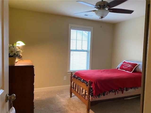 bedroom featuring ceiling fan and light carpet