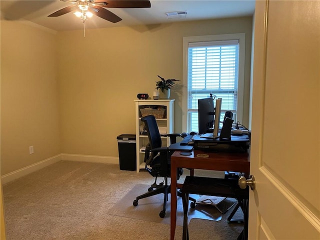 carpeted home office with ceiling fan